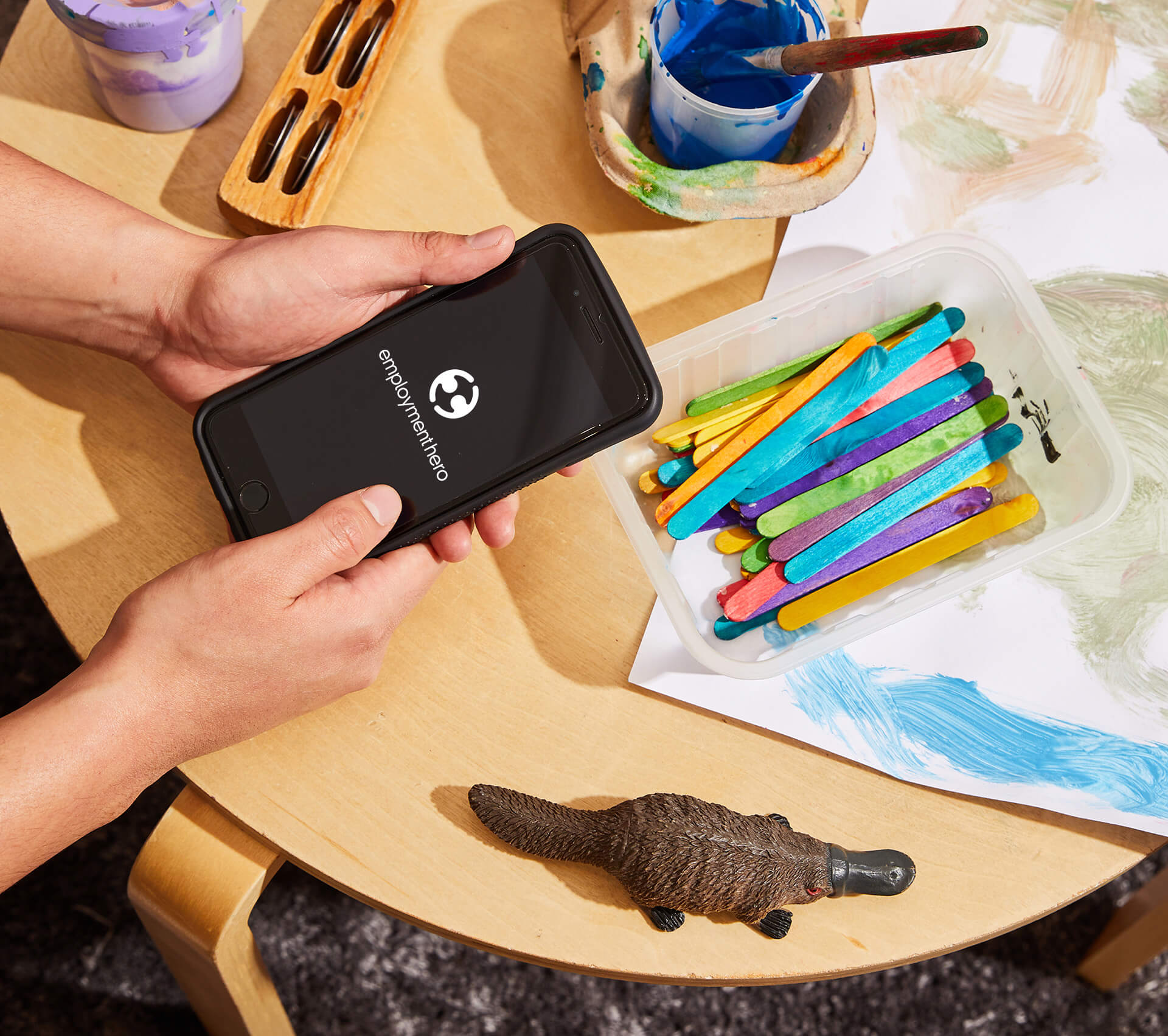 An iPhone with the Employment Hero logo displayed