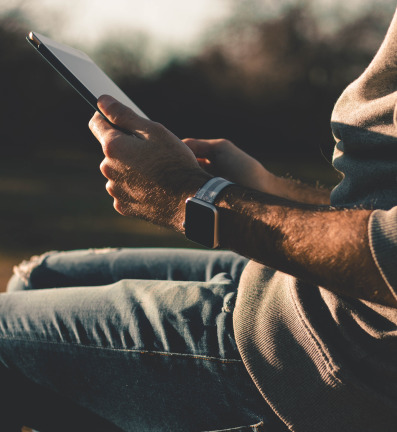 Close up of a man holding a tablet.
