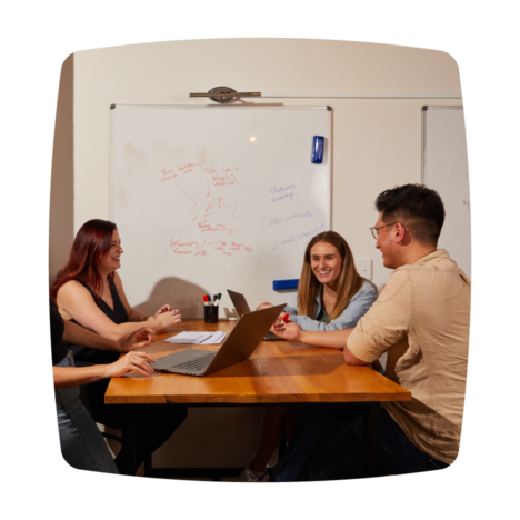 Smiling colleagues having a group discussion.
