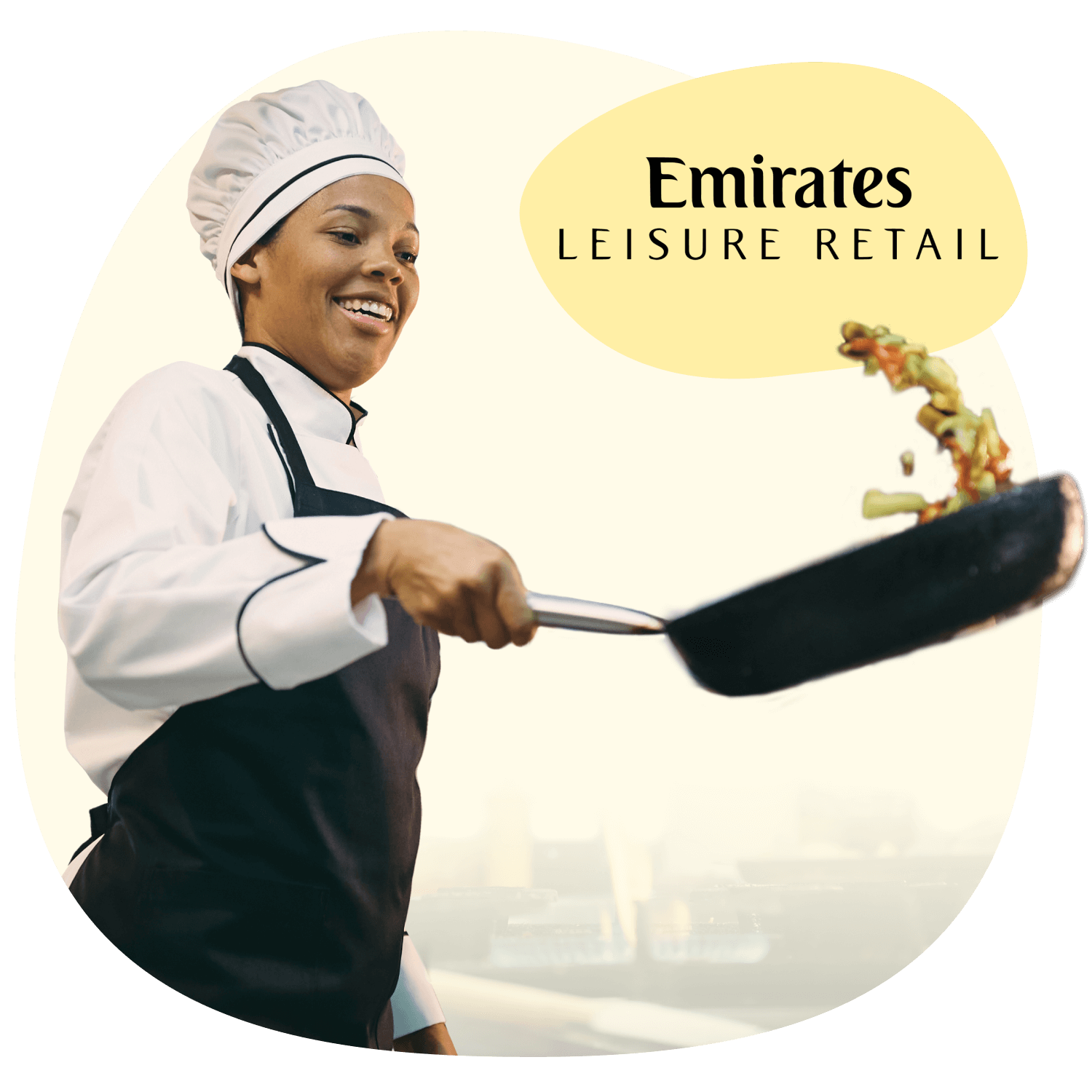 A smiling chef flipping vegetables in a pan, with the text 'Emirates Leisure Retail' displayed in the background against a soft yellow shape.