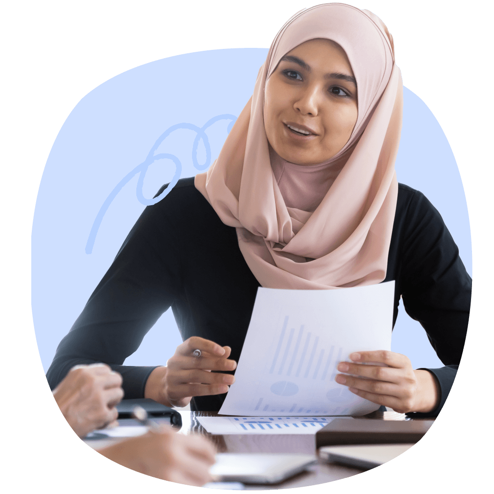 A woman in a hijab, holding a paper that contains charts