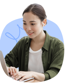 A smiling woman wearing green collared shirt typing on her laptop.