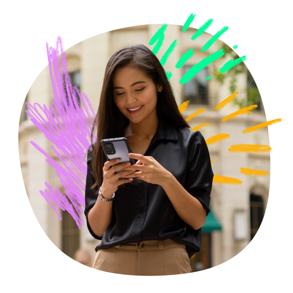 A smiling young woman browsing on her phone while standing against a building wall with artistic purple and teal brushstroke accents.