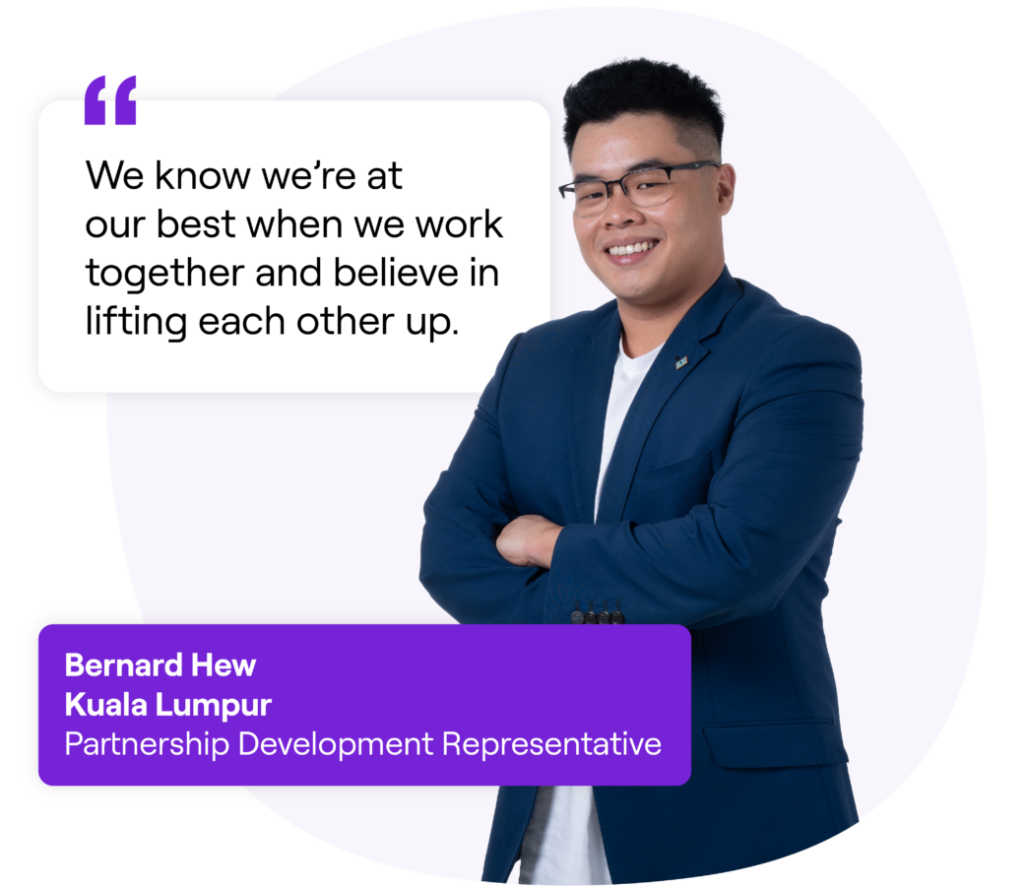 A smiling man wearing glasses and a dark blue suit next to a quote that reads: 'We know we’re at our best when we work together and believe in lifting each other up.' Text box below reads: 'Bernard Hew, Kuala Lumpur, Partnership Development Representative.'