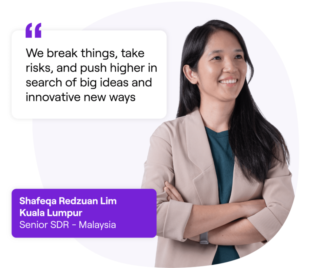 A smiling woman wearing a light-brown suit standing with folded arms. Next to her is a quote that reads: 'We break things, take risks, and push higher in search of big ideas and innovative new ways.' Text box below reads: 'Shafeqa Redzuan Lim, Kuala Lumpur, Senior SDR - Malaysia.'